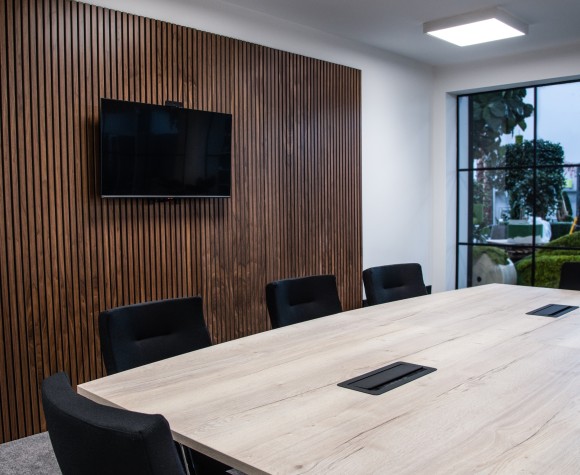 a meeting room set up with chairs and a table
