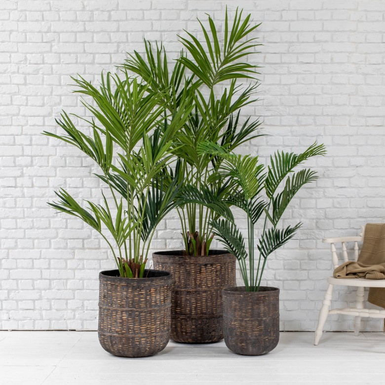 small artificial palms displayed in bamboo pots