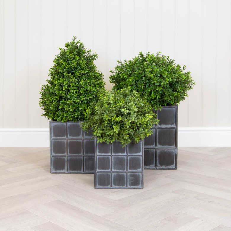 artificial topiary in planters